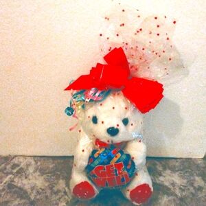 White plush Teddy holds Get Well balloon